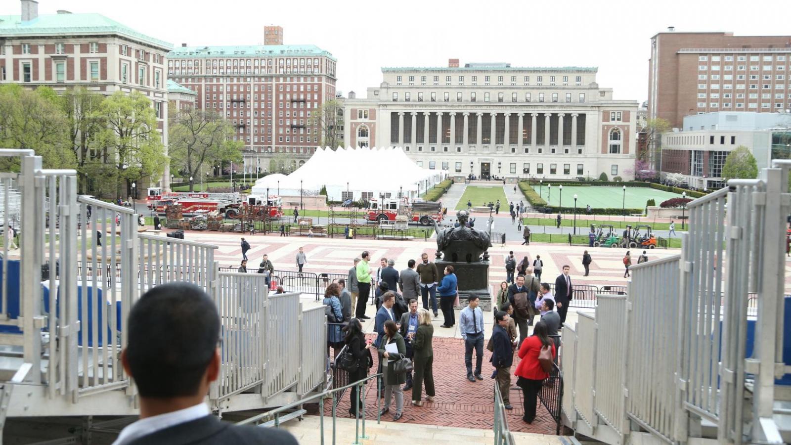 View down steps to south lawn of university of columbia campus with open lawn and large buildings