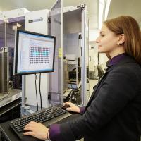 Researcher looks at data on a computer.